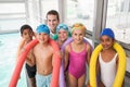 Swimming coach with his students poolside Royalty Free Stock Photo