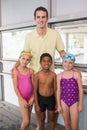 Swimming coach with his students poolside Royalty Free Stock Photo