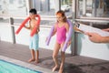Swimming coach holding clipboard poolside Royalty Free Stock Photo