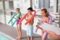 Swimming coach holding clipboard poolside Royalty Free Stock Photo