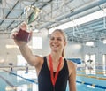 Swimming, competition and winner with trophy and medal, achievement or happiness from success in the race or pool Royalty Free Stock Photo