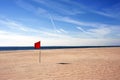 Red warning flag flapping in the wind on beach at sunny day at Coney Island, New York Royalty Free Stock Photo