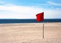 Red warning flag flapping in the wind on beach at sunny day at Coney Island, New York Royalty Free Stock Photo