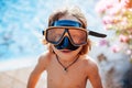 Little boy with goggles pose on camera around seascape