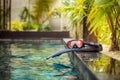 Swimming flippers and snorkeling mask laying on the edge of the pool Royalty Free Stock Photo