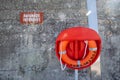 Swimming forbidden sign in French, orange life buoy