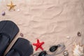 Swimming goggles and flippers on the sand with shells and starfishes. Royalty Free Stock Photo