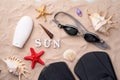 Swimming goggles, flippers and sunscreen on the sand with shells and starfishes. Royalty Free Stock Photo