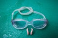 Swimming goggles with nose clip