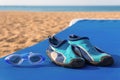 Swimming goggles with water shoes on a beach bed Royalty Free Stock Photo