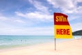 Swimming here sign on the beach Royalty Free Stock Photo