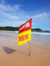 Swimming here sign flaf for security information on the beach Royalty Free Stock Photo