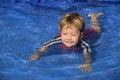 Swimming lessons: Cute baby girl n the pool Royalty Free Stock Photo