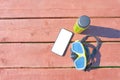 Swimming mask, bottle of smoothie and smartphone