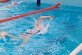 Swimming pool athlete training indoors for professional competition. Teenager swimmer doing free style Royalty Free Stock Photo