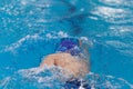 Swimming pool athlete training indoors for professional competition. Teenager swimmer doing free style Royalty Free Stock Photo