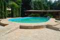 Swimming pool with blue water in the back yard. Royalty Free Stock Photo