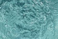 Swimming pool backgrounds. Turquoise background texture of bubbling and rippled pattern of water in a swimming pool with sun