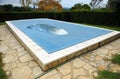 Swimming pool with a blue tarp for protection in winter Royalty Free Stock Photo