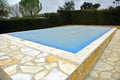 Swimming pool with a blue tarp for protection in winter Royalty Free Stock Photo