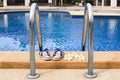 Swimming pool blue water in luxury hotel, resort leisure, spa relax, white plumeria frangipani flowers, women flip flops, poolside Royalty Free Stock Photo