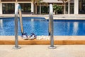 Swimming pool blue water in luxury hotel, resort leisure, spa relax, white plumeria frangipani flowers, women flip flops, poolside Royalty Free Stock Photo