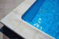 Swimming pool with blue water outdoors with stone gray edge Royalty Free Stock Photo