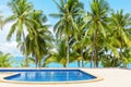 Swimming pool blue water, sea beach poolside, tropical island nature, green palm trees, ocean coast, summer holidays, vacation Royalty Free Stock Photo