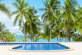 Swimming pool blue water, sea beach poolside, tropical island nature, green palm trees, ocean coast, summer holidays, vacation Royalty Free Stock Photo