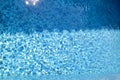 Swimming pool bottom caustics ripple and flow with waves background. Surface of blue swimming pool, background of water. Royalty Free Stock Photo