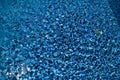 Swimming pool bottom caustics ripple and flow with waves background. Surface of blue swimming pool, background of water. Royalty Free Stock Photo