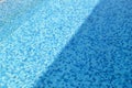 Swimming pool bottom caustics ripple and flow with waves background. Surface of blue swimming pool, background of water. Royalty Free Stock Photo