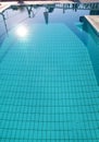 Swimming pool bottom caustics ripple and flow with waves background. Surface of blue swimming pool, background of water. Royalty Free Stock Photo