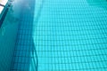 Swimming pool bottom caustics ripple and flow with waves background. Surface of blue swimming pool, background of water. Royalty Free Stock Photo