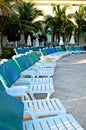 Swimming pool chairs and green palms