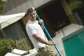 Swimming pool cleaner, professional cleaning service at work. Royalty Free Stock Photo