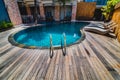 Swimming pool with clear blue water and recliners