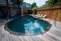 Swimming pool with clear blue water and recliners