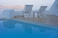 Swimming pool and deck chairs with sea view Royalty Free Stock Photo