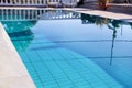 Swimming pool design modern architecture of luxury holiday villa. Relax near exotic swimming pool with handrail, deck chairs, sun. Royalty Free Stock Photo