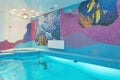 Swimming pool design with mosaic fish on the wall Royalty Free Stock Photo