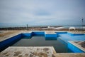 Swimming pool with dirty water at closed empty beach Royalty Free Stock Photo