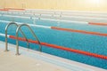 Swimming pool with divided lanes for competition and training and a ladder for going out and diving in the open air, illuminated Royalty Free Stock Photo