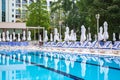 Swimming pool with empty loungers and closed umbrellas at luxury hotel Royalty Free Stock Photo