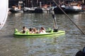 Swimming pool floating in the water of the river or canal of the port of Rotterdam. Young Dutch students have fun and spend time