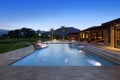 Swimming pool with fountain outside luxurious manor house Royalty Free Stock Photo