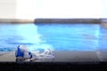 Swimming pool with goggles on poolside in summer beach holiday concept Royalty Free Stock Photo