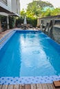 Swimming pool of hotel.Beautiful luxury outdoor swimming pool with stair in hotel and resort for holiday travel Royalty Free Stock Photo