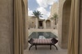 Swimming pool in a hotel in Dubai with bench and palm tree Royalty Free Stock Photo