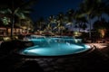Swimming Pool in Hotel Resort with Nature View Surrounded by Palm Tree in Calm Night